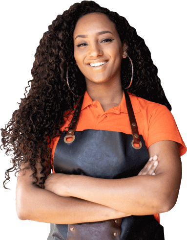 female chef with crossed arms in leather apron