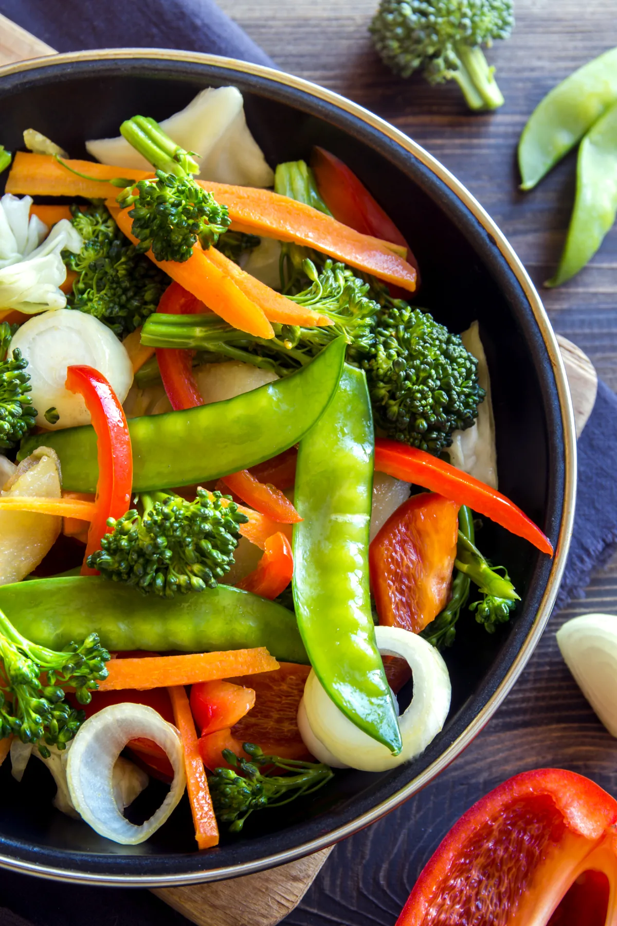 Vegetable stir-fry with broccoli, snow peas, carrots and peppers