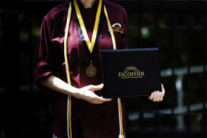 Escoffier graduate posing with degree