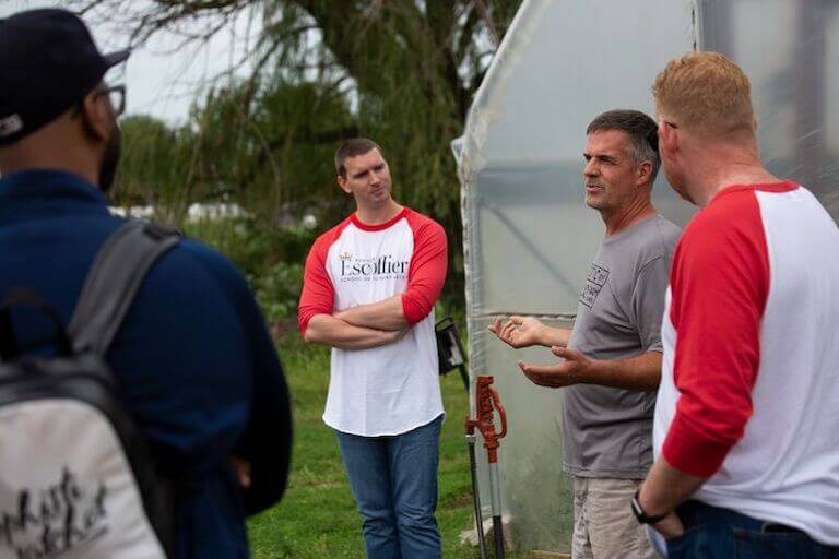 Farmer talking to Escoffier students on a farm