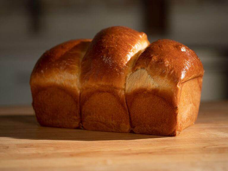 Loaf of baked Brioche on a wooden table