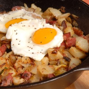 Eggs and potatoes being cooked. 