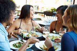 4 woman having a dinner at a restaurant