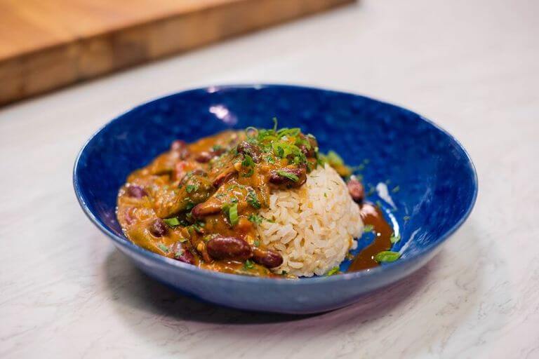 Gumbo and rice in a blue bowl