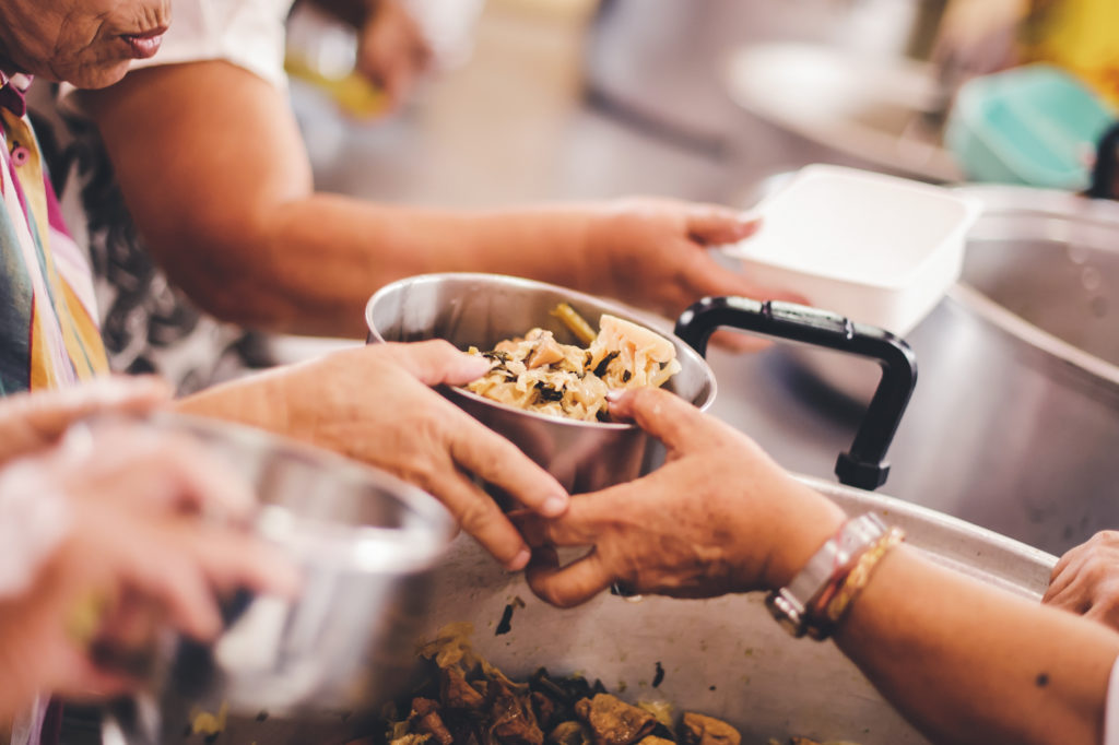 Volunteers donate free charity food to the homeless