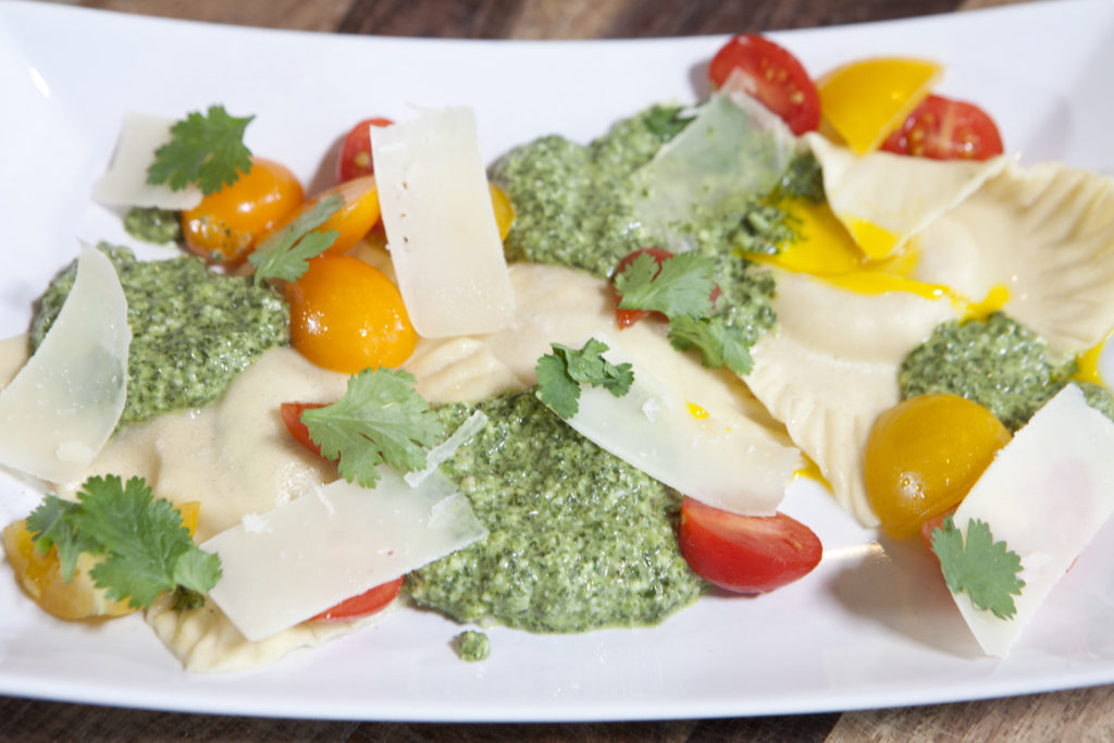 Egg yolk ravioli and pesto sauce