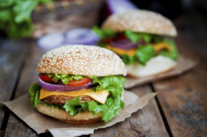 Closeup of home made burgers on wooden background