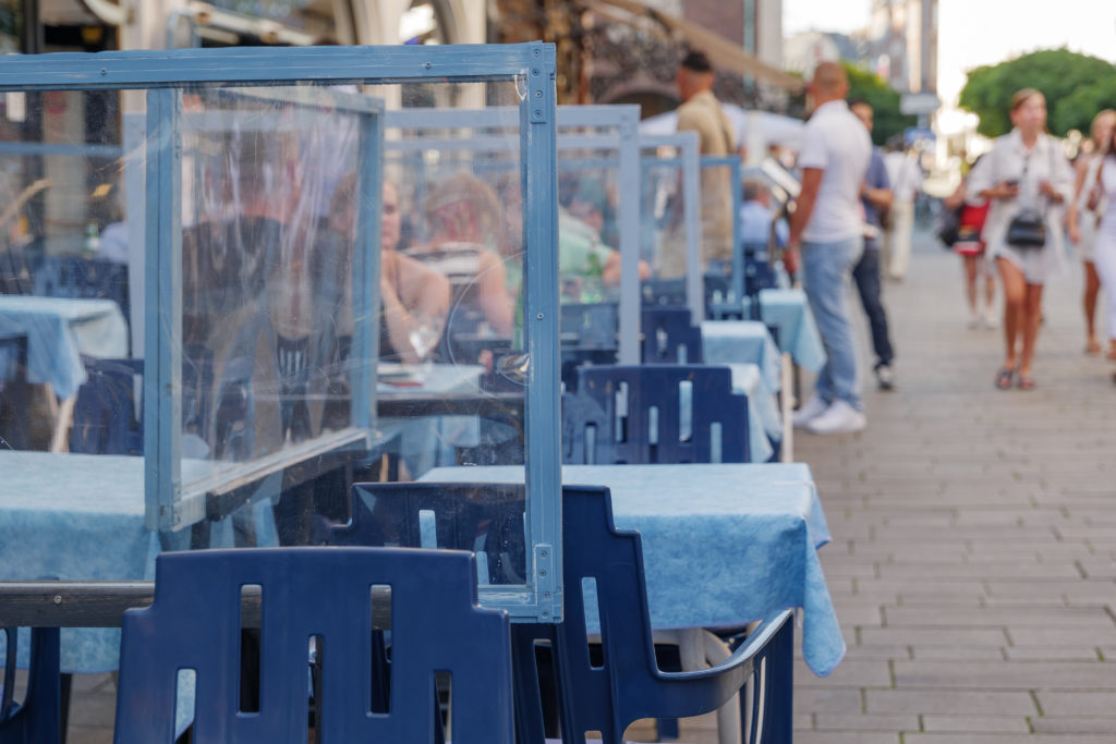 Outdoor seated restaurant with blue tables and chairs