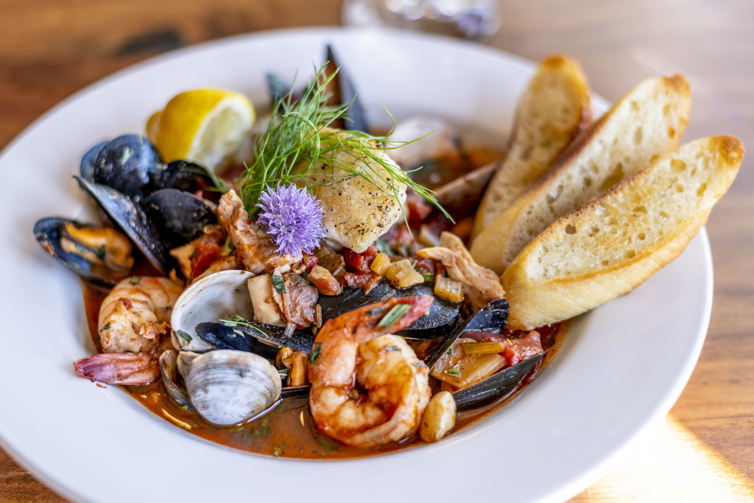 Bouillabaisse Seafood Soup Close-Up with Shrimp, Muscles, Clams, Fish, Fennel and Grilled Bread