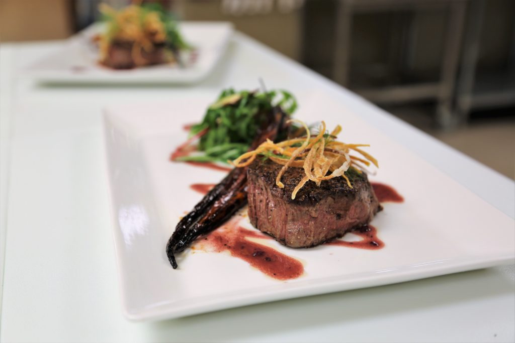 Steak dish on a white plate