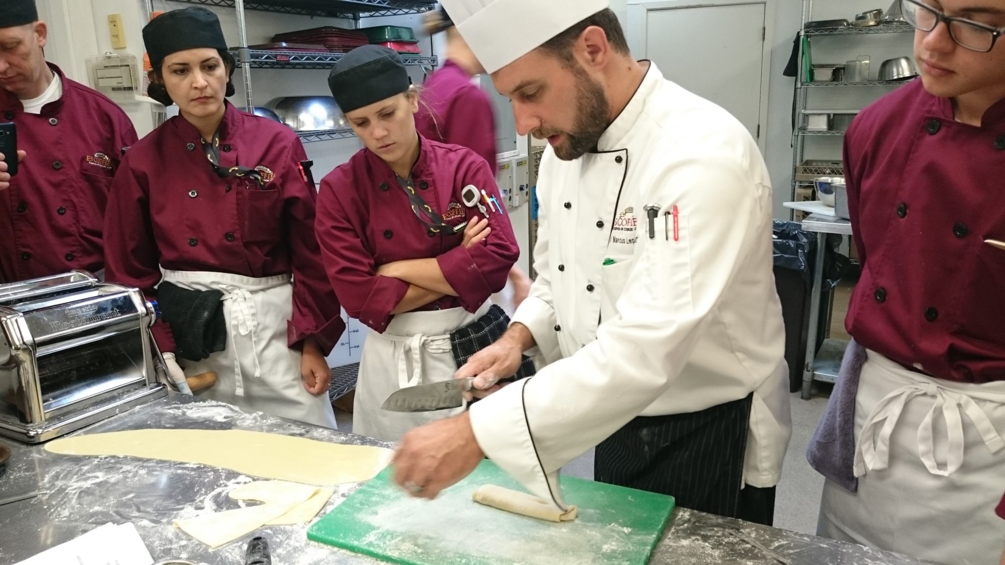 Chef Marcus Lepke giving a fish fabrication demonstration to students.