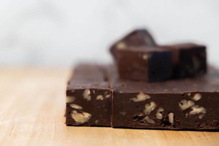 Fudge with nuts sitting on a wood table