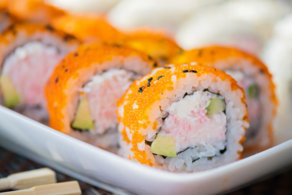 California maki sushi with masago. Roll made of crab meat, avocado, cucumber and masago. Shallow depth of field.