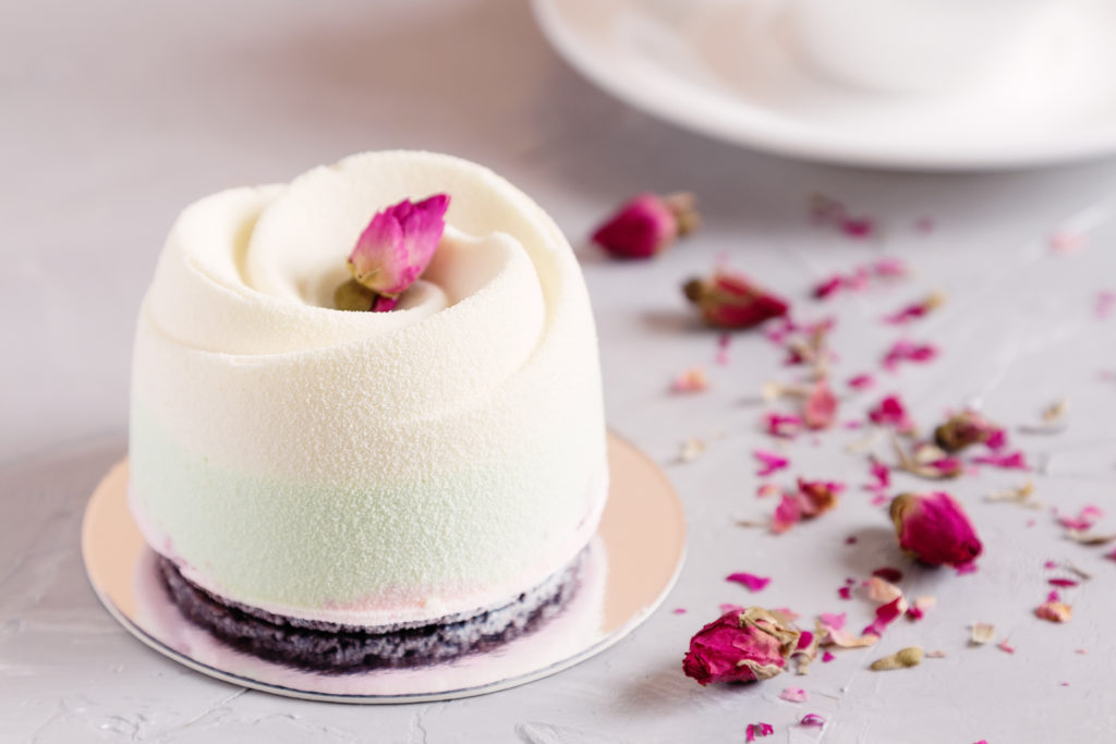 White pink flower shaped dessert cake with petals