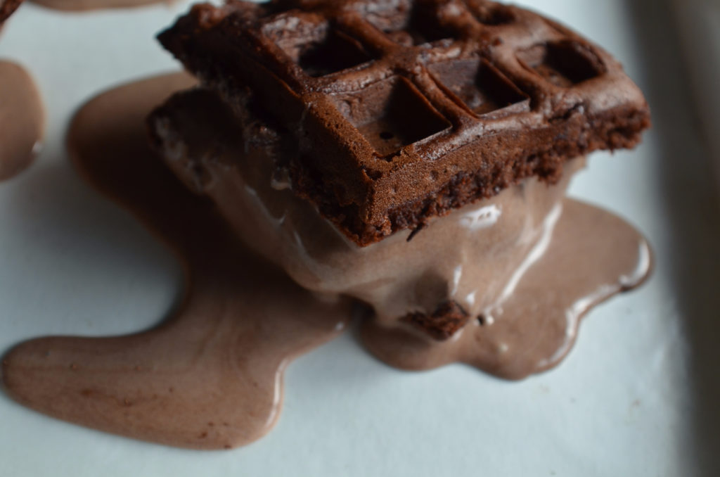 Chocolate ice cream sandwich made with brownie waffles, ice cream melting