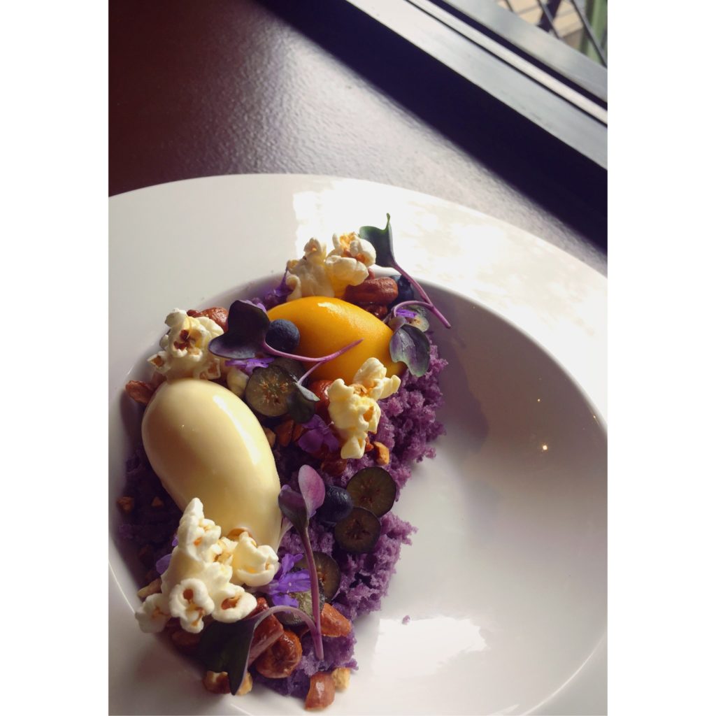 A dish Mary created for Vince Young's Steakhouse: blueberry cake, fresh blueberries, mango sorbet, mango fluid gel, sweet corn ice cream, popcorn and candied cashews. 