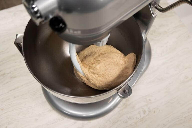 Electric mixer using the hook attachment to mix bread dough