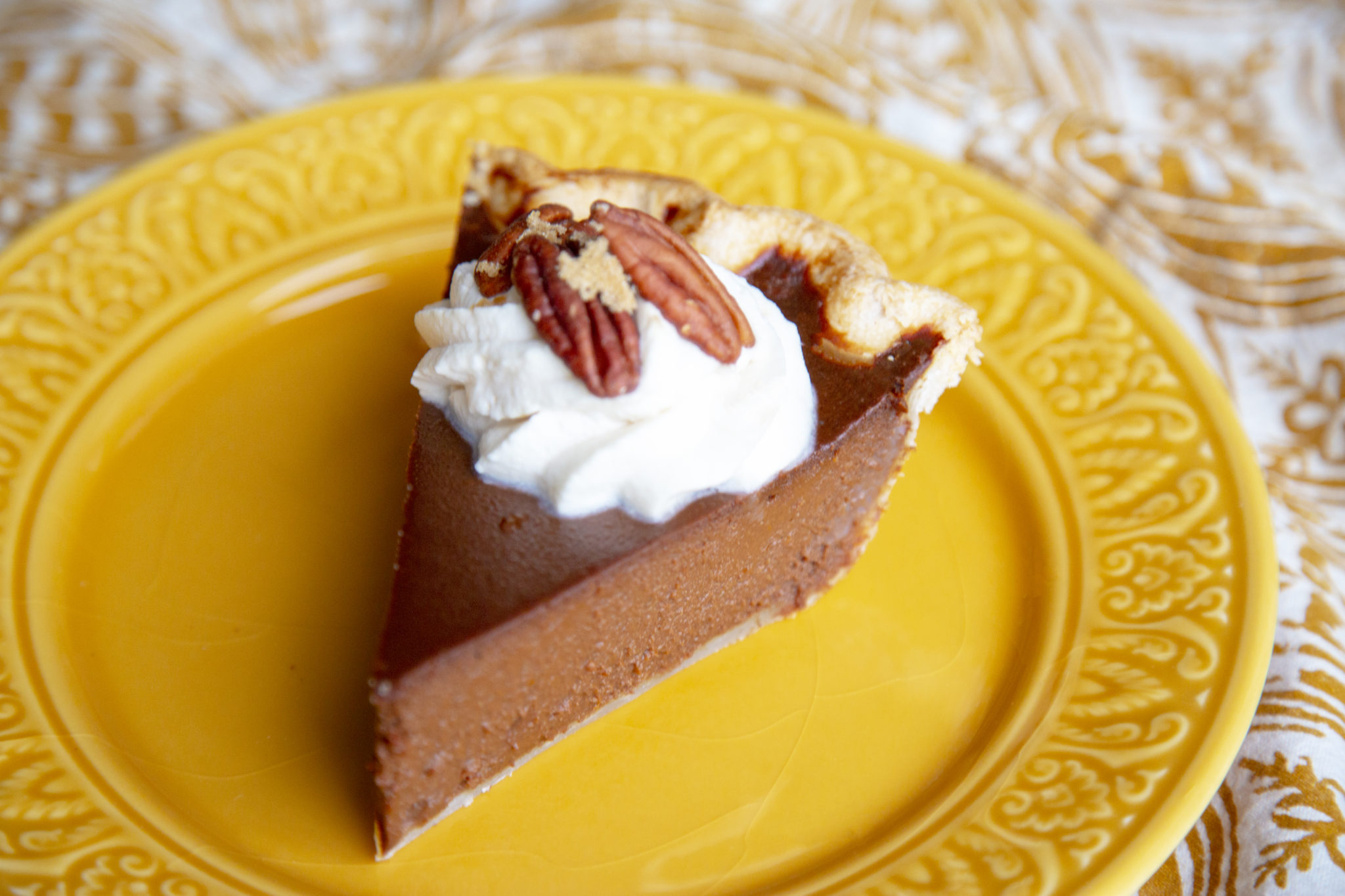 Serve this decadent pie with candied pecans and bourbon whipped cream. 