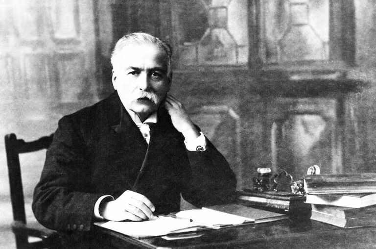 Auguste Escoffier sitting at a desk