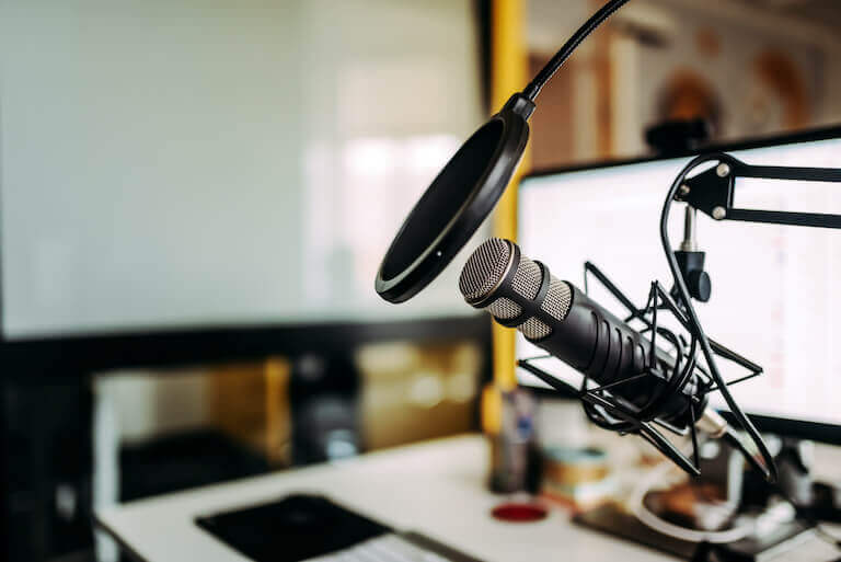 Close-up image of microphone in podcast studio.