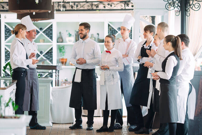 Restaurant staff speaking with the head chef