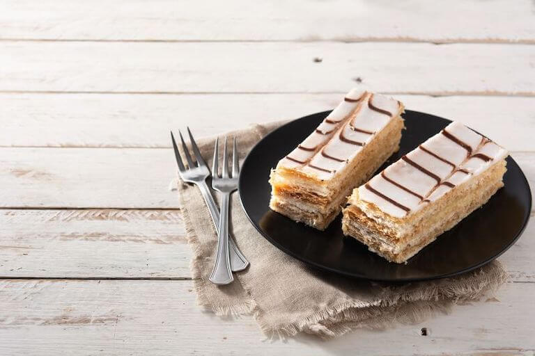 French mille-feuille on white wooden table