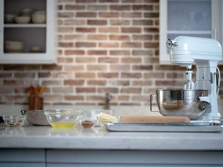 Oil, butter, and other ingredients for Almond Tuile separated into glass bowls on a counter