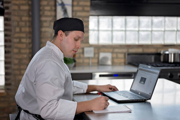 Online culinary student taking a course on the computer