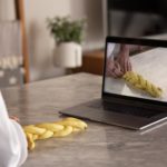 Culinary student following food styling technique on computer
