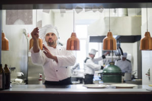 Chef turning on lamp in commercial kitchen