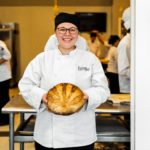 Escoffier baking and pastry student holding baked bread
