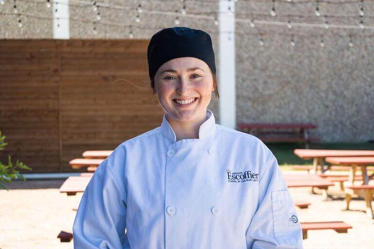 Escoffier student standing outside in school uniform smiling 