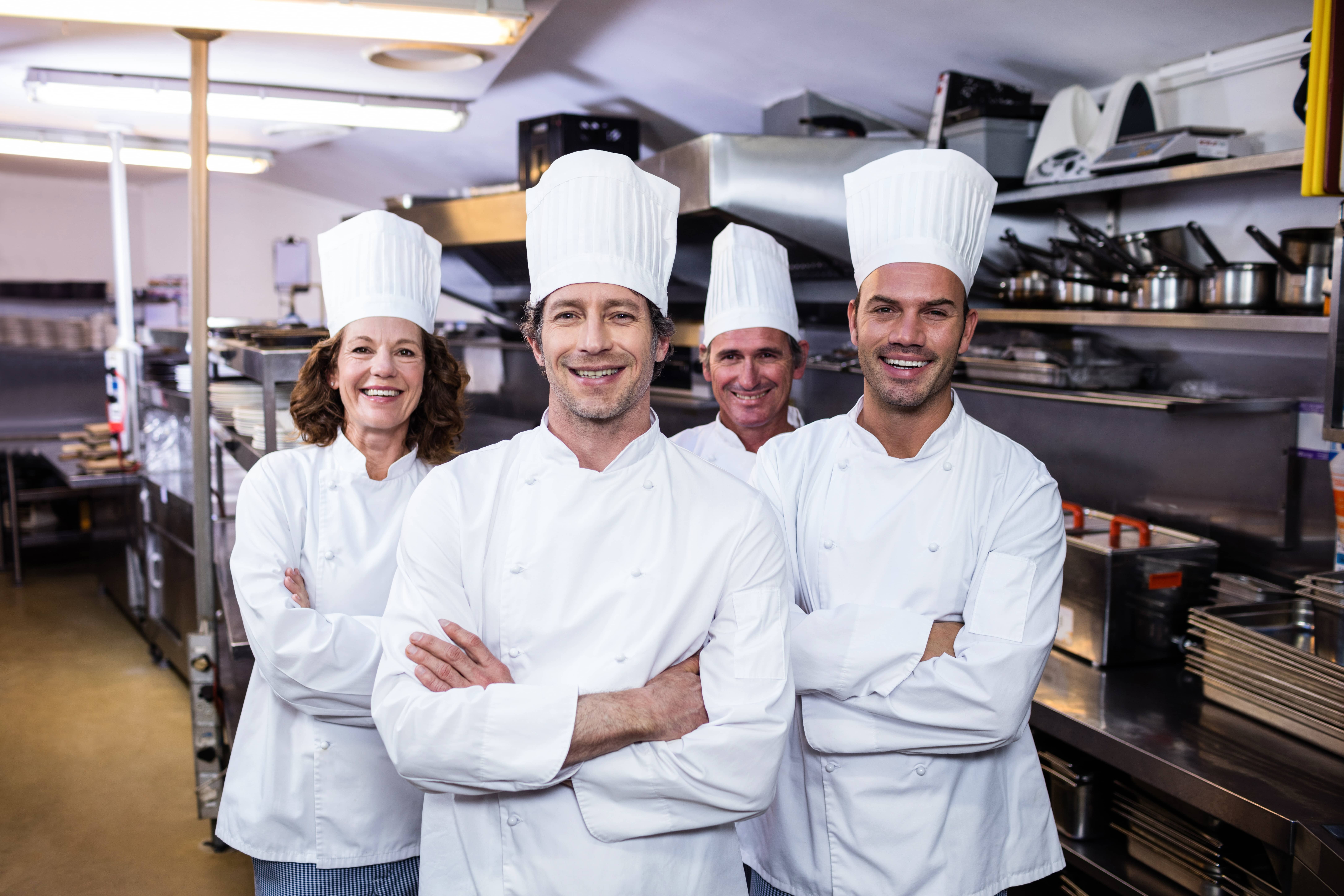 Group of happy chefs smiling at the camera 