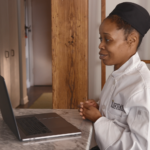 Female online culinary student watching a lesson on computer