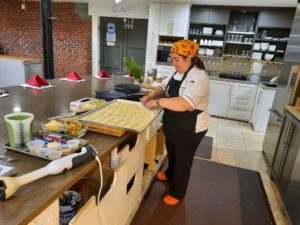 Rhonda Adkins, Escoffier graduate, prepping for a cooking demonstration class at Pizzaz.