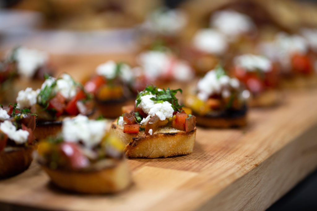 Bread cheese and tomato appetizer on a wooden board