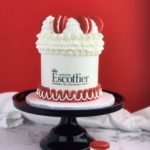 Escoffier logo cake-white with red piping and red macarons