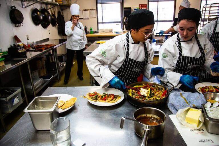 Students in the kitchen making tacos and competing scholarship competition