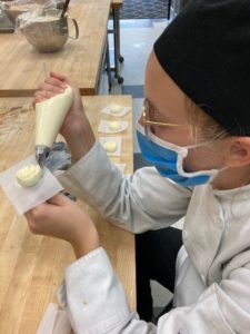 Escoffier student making buttercream roses