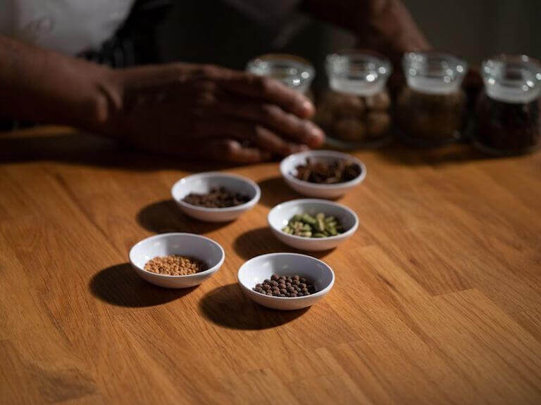 Assorted spices in bowls on a wooden table