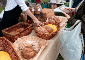 Woman selling organic bread at outdoors farmers market