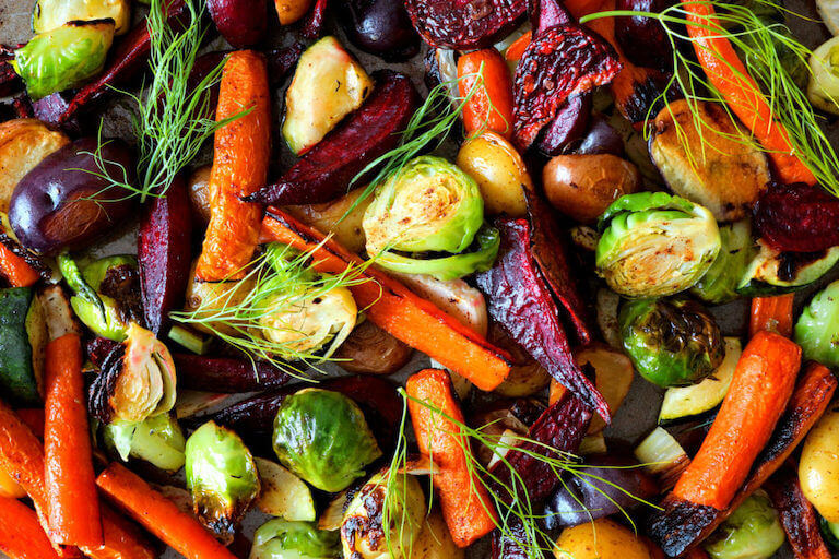 Roasted vegetable medley of Brussels sprouts, carrots, and beets topped with fennel fronds.