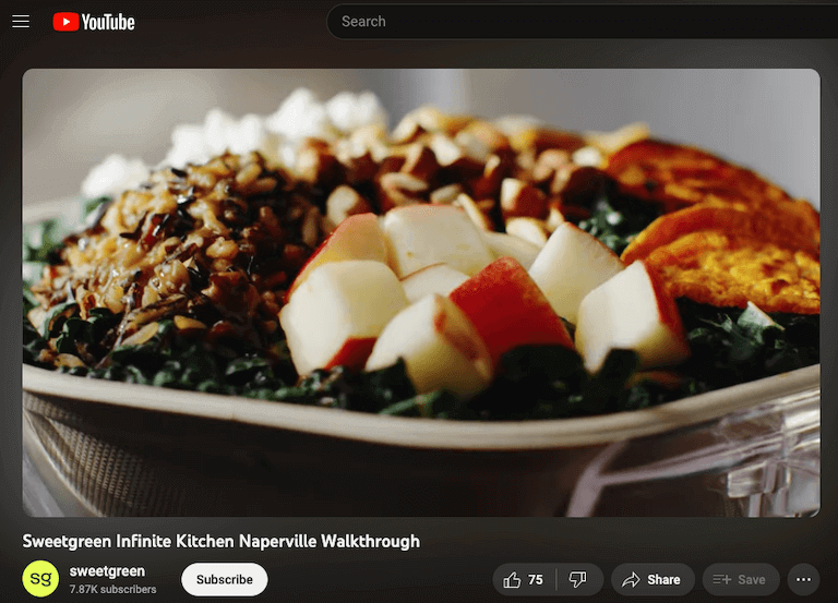 Screenshot of a YouTube video depicting a close up image of a salad bowl with kale, chopped apple, grains, roasted vegetables, and nuts.