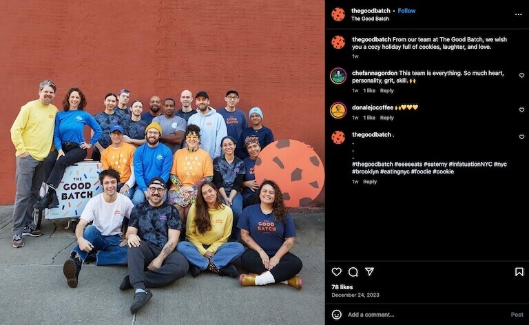 Screenshot of an Instagram post depicting a group of bakery workers smiling and posing for the camera in front of a red brick wall.
