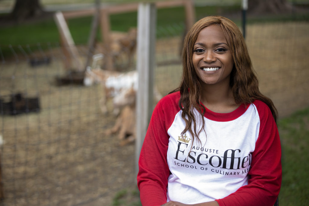 Tiffany Moore on farm wearing red and white Escoffier logo shirt