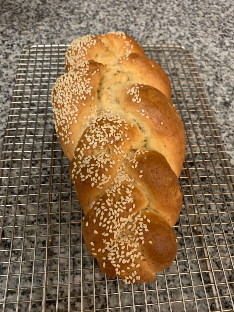 Baked bread in knot with seeds as toppings