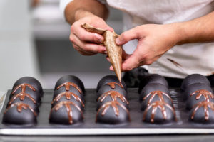 Chocolatier decorating gourmet chocolate candies