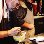 Escoffier Online Graduate & Executive Chef/Owner Lance McWhorter plating a seafood dish in his restaurant