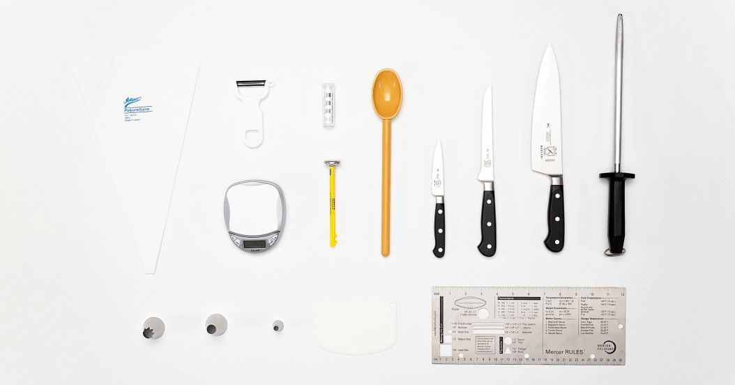 Kitchen toolkit laid out on a white table