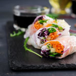 Spring vegetable rolls appetizer on black plate